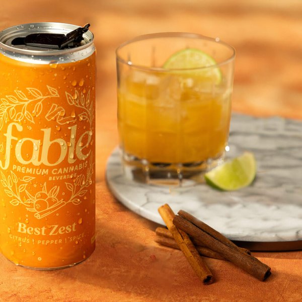 Best Zest can sitting on table with cocktail glass and spices